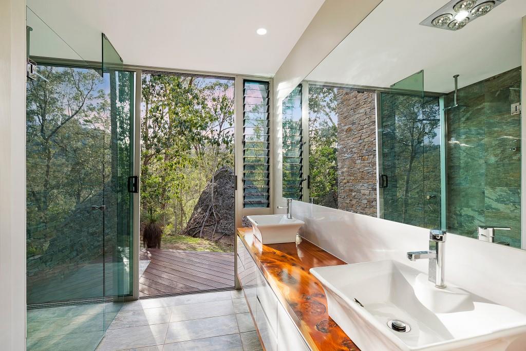 Tall narrow Breezway louvres in the bathroom keep mirrors steam-free